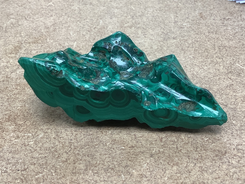 A Chinese malachite brush rest, Qing dynasty, 9.5cm wide